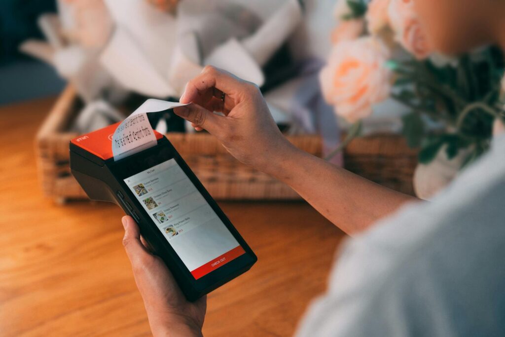 A Close-Up Shot of a Person Holding a Payment Terminal