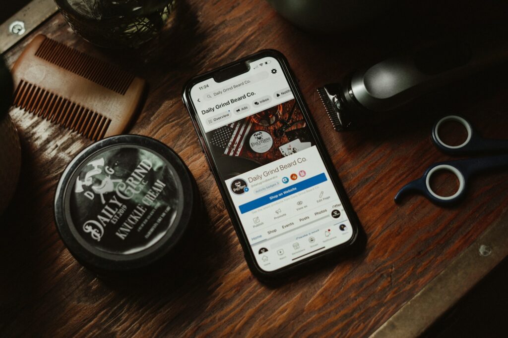 a phone sitting on top of a wooden table next to a comb