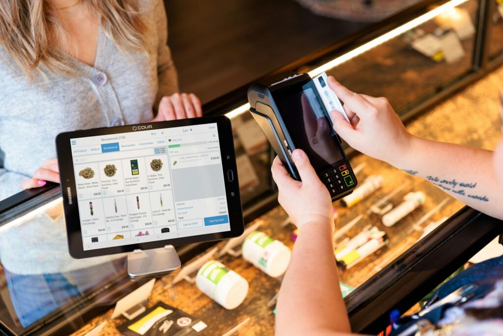 a person holding a tablet in front of a display case