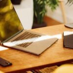 A laptop computer sitting on top of a wooden desk