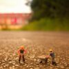 Selective Focus Photography of Two Men Builder Figurines