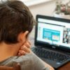 boy in gray shirt using black laptop computer